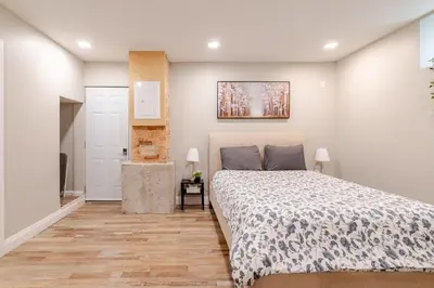 a bedroom with a bed and a painting on the wall at ENTIRE 1 BEDROOM APARTMENT ACROSS FROM GOOGLE - br1 in Kitchener
