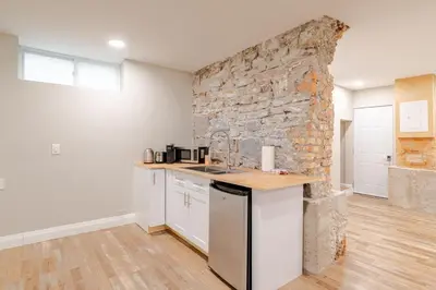 a kitchen with a counter and a stone wall at ENTIRE 1 BEDROOM APARTMENT ACROSS FROM GOOGLE - br1 in Kitchener