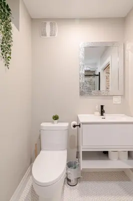a white bathroom with a toilet and a sink at ENTIRE 1 BEDROOM APARTMENT ACROSS FROM GOOGLE - br1 in Kitchener