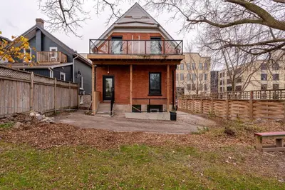 a house with a balcony on top of it at ENTIRE 1 BEDROOM APARTMENT ACROSS FROM GOOGLE - br1 in Kitchener
