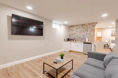 a living room with a couch and a tv on a wall at ENTIRE 1 BEDROOM APARTMENT ACROSS FROM GOOGLE - br1 in Kitchener