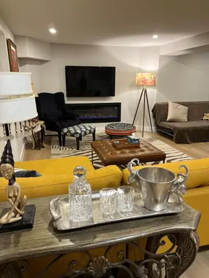 a living room with a yellow couch and a table at Luxurious Private Apartment in Oakville