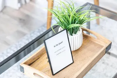 a tablet sitting on a table with a potted plant at 1 Bed, 1 Bath Lovely Open Concept Resort Condo in Blue Mountains