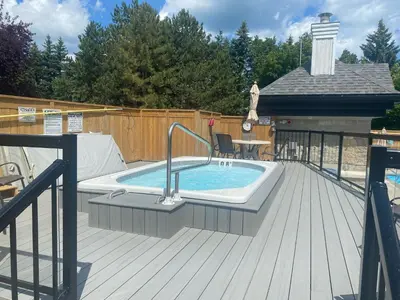 a pool on a deck with a hot tub at 1 Bed, 1 Bath Lovely Open Concept Resort Condo in Blue Mountains
