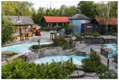 a backyard with a swimming pool and a house at 1 Bed, 1 Bath Lovely Open Concept Resort Condo in Blue Mountains