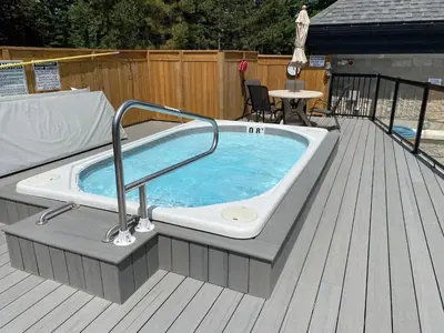 a jacuzzi tub sitting on top of a deck at 1 Bed, 1 Bath Lovely Open Concept Resort Condo in Blue Mountains