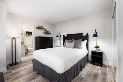 a bedroom with a large bed and a bathroom at 1 Bed, 1 Bath Lovely Open Concept Resort Condo in Blue Mountains