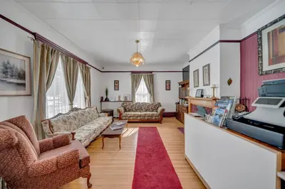 a living room with two couches and a piano at Marmora and Lake Inn and Victorian Diner - Grand Victorian Suites- Level 2 in Marmora