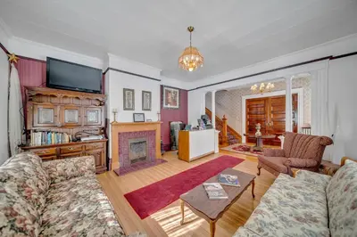 a living room with a couch and a fireplace at Marmora and Lake Inn and Victorian Diner - Grand Victorian Suites- Level 2 in Marmora