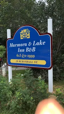 a sign for a manorman and lake im beeb at Marmora and Lake Inn and Victorian Diner - Grand Victorian Suites- Level 2 in Marmora