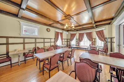 a restaurant with tables and chairs in a room at Marmora and Lake Inn and Victorian Diner - Grand Victorian Suites- Level 2 in Marmora