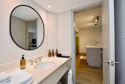 a bathroom with a sink and a mirror at Lux Jacuzzi Suite - Top Level in Shanty Bay
