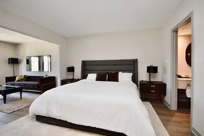 a bedroom with a large white bed and a couch at Relaxing Top Level Studio in Edgar