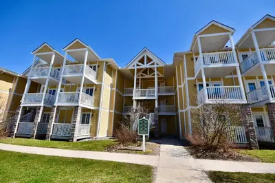 a large yellow apartment building with white balconies at Relaxing Top Level Studio in Edgar