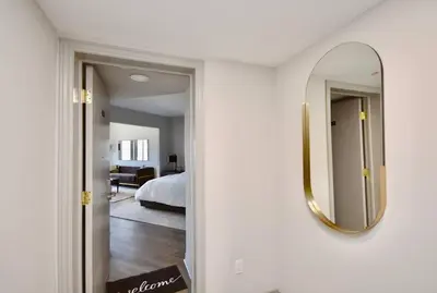 a mirror on a wall next to a bedroom at Relaxing Top Level Studio in Edgar