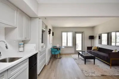 a kitchen and a living room with a couch at Relaxing Top Level Studio in Edgar