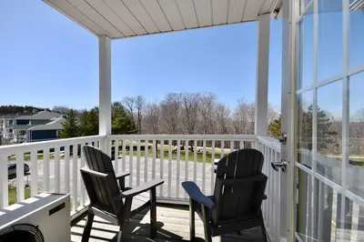 a porch with three chairs and a table and windows at Relaxing Top Level Studio in Edgar