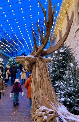 a sculpture of a tree with people walking by christmas trees at Stone Mill Retreat - Rustic Cozy Getaway with Loft! in Fergus