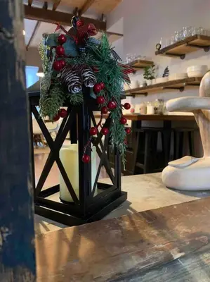 a vase with christmas decorations on top of a table at Stone Mill Retreat - Rustic Cozy Getaway with Loft! in Fergus