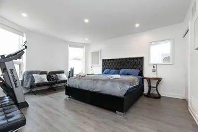 a bedroom with a large bed and a couch at Grand 3 BR Toronto Victorian Entire Home in Toronto