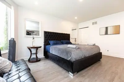 a bedroom with a large bed and a couch at Grand 3 BR Toronto Victorian Entire Home in Toronto