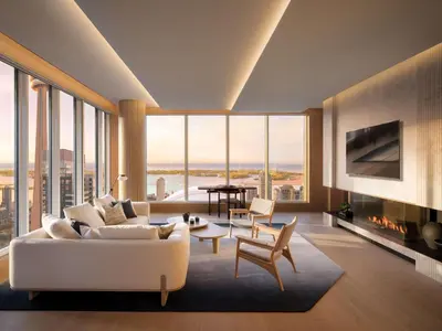 a living room with a white couch and a fireplace at Nobu Hotel Toronto in Toronto