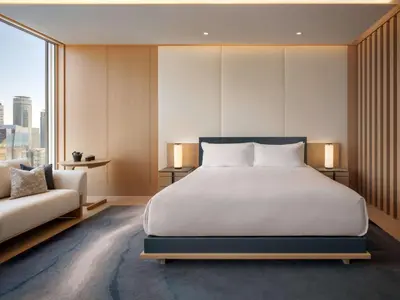 a bedroom with a large bed and a couch at Nobu Hotel Toronto in Toronto