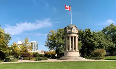 a clock tower with a flag on top of it at Newly Built Condo with Amazing Views in Kitchener