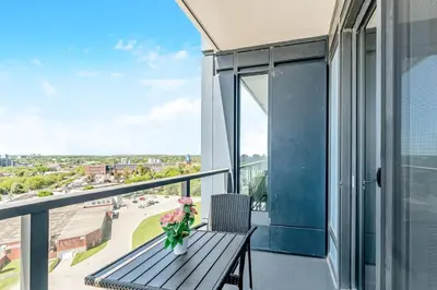 a balcony with a bench and a view of a city at Modern High Rise King bed Condo with Private Balcony in Kitchener