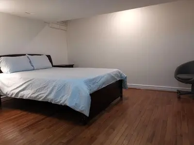 a bedroom with a bed and a desk and a chair at Cozy Private Rooms in Basement in Richmond Hill
