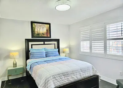 a bedroom with a bed and two windows at Beautiful 3 bedroom Entire detached home in Whitby