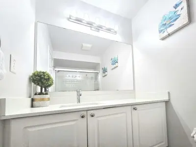 a bathroom with a sink and a large mirror at Beautiful 3 bedroom Entire detached home in Whitby