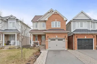 a brick house with a garage at Beautiful 3 bedroom Entire detached home in Whitby