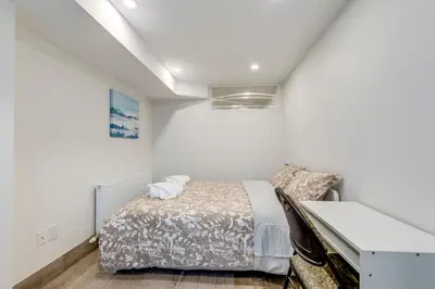 a bedroom with a bed and a desk at Midtown 2 Bedroom Apartment in Toronto