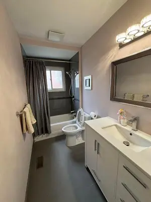 a bathroom with a toilet and a sink and a mirror at Willowdale in Toronto