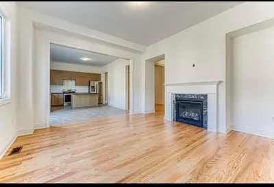 an empty living room with a fireplace at Bright bedroom with private bathroom in Richmond Hill