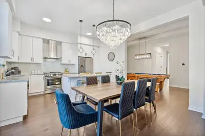 a kitchen and dining room with a wooden table and chairs at Luxury Vacation Home Near Lake Pool Table in Barrie