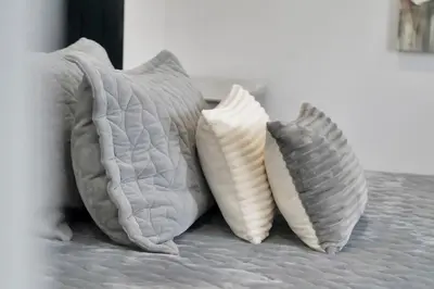 three pillows sitting on top of a bed at Luxe Lodges Lake Erie in Port Dover