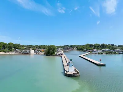 a boat is docked at a dock in the water at Luxe Lodges Lake Erie in Port Dover