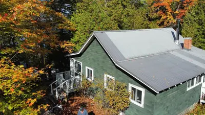 an aerial view of a green house with a metal roof at Birkswyld waterfront cottage Mary Lake in Huntsville
