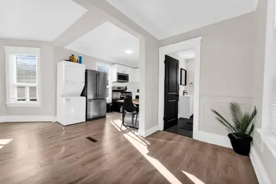 a kitchen with a refrigerator and a dining room at RentX 3Bed Cozy Home - Hospital GO 2ParkingWi-Fi in Hamilton