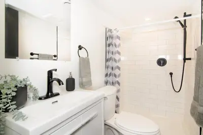 a bathroom with a sink and a toilet and a shower at RentX Modern Suite - Near GO Hospital Parking in Hamilton