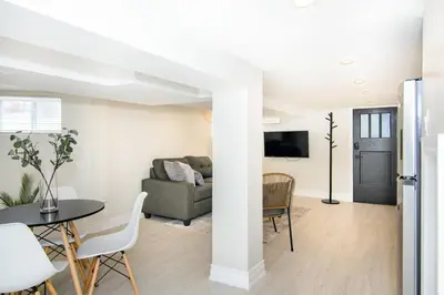 a living room with a couch and a table at RentX Modern Suite - Near GO Hospital Parking in Hamilton
