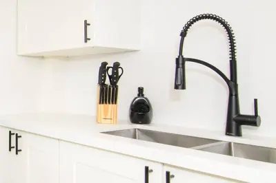 a kitchen counter with a sink and a knife block at RentX Modern Suite - Near GO Hospital Parking in Hamilton