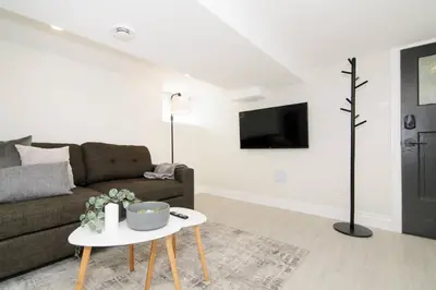 a living room with a couch and a table at RentX Modern Suite - Near GO Hospital Parking in Hamilton