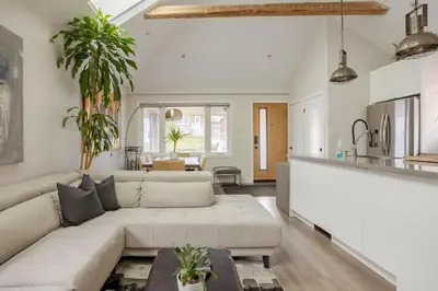 a living room with a couch and a table at Lonborough Ave Upstairs in Toronto