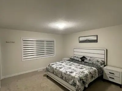 a bedroom with a bed and a window at Cozy 3-Bedrooms T-Home #Niagara in Thorold