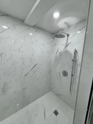 a bathroom with a shower with white marble at Entire bungalow, full privacy, free parking in Oshawa