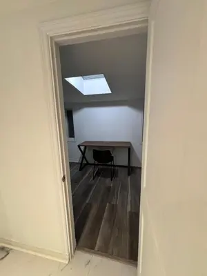 a dining room with a table and a skylight at Entire bungalow, full privacy, free parking in Oshawa