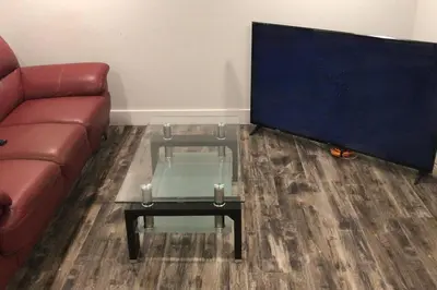 a living room with a couch and a glass coffee table at Affordable 2BR Family Friendly Basement Apt in Bowmanville